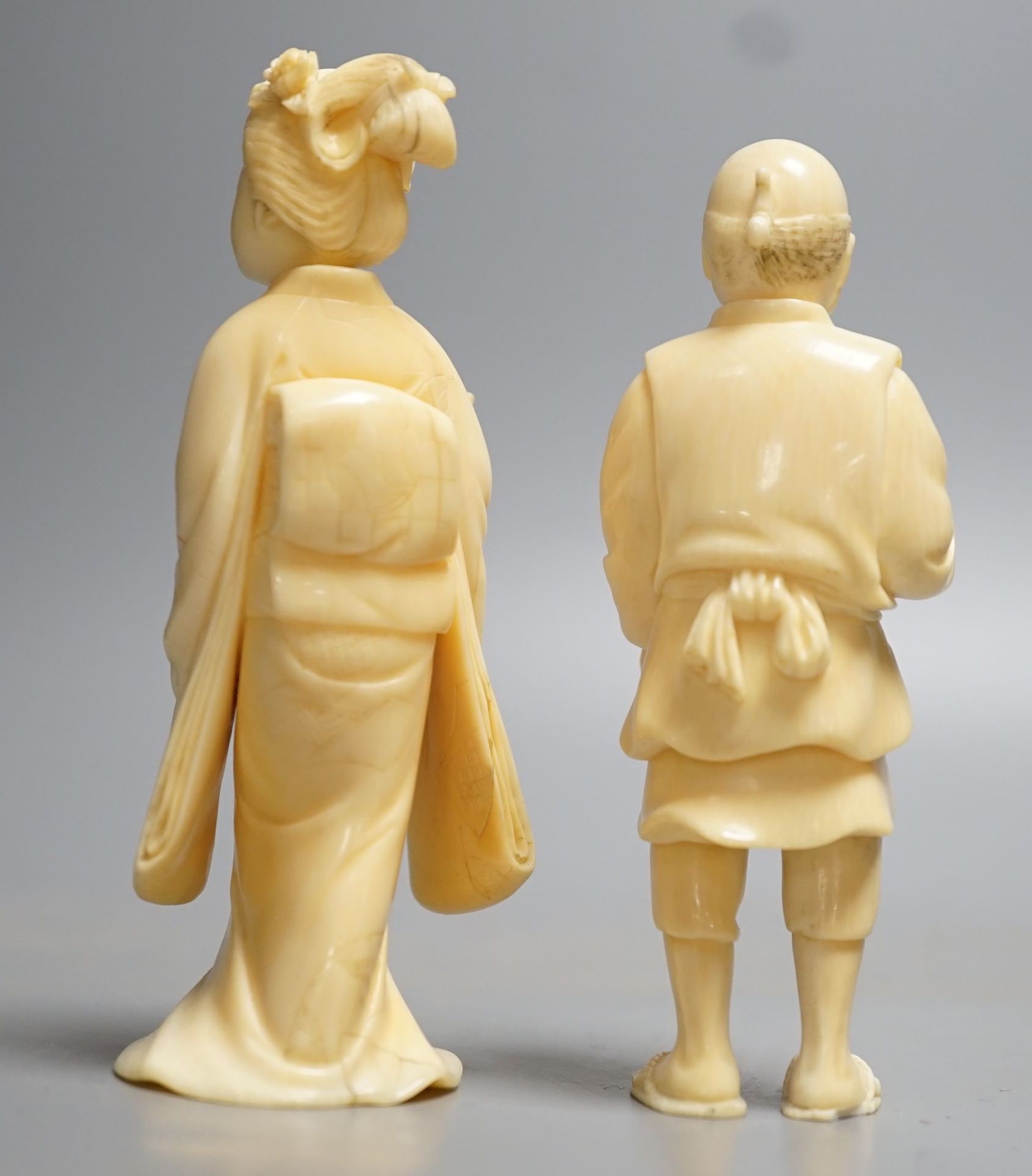 Two Japanese ivory figures of a man and a bijin, Meiji period, both signed to base, 10cm